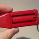 Hand holding the Heinz Packet Roller upward